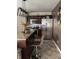 The kitchen has stainless steel appliances, an island with chairs, and modern lighting at 10835 Spirit Dr, Ingalls, IN 46048