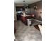 Open kitchen featuring stainless steel appliances, island with bar stools, and modern fixtures at 10835 Spirit Dr, Ingalls, IN 46048