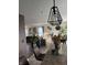 View of the living room, dining table, bar island, and modern furnishings from the kitchen area at 10835 Spirit Dr, Ingalls, IN 46048