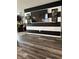 The living room features a TV on a black and white striped wall, wood-style floors, and modern decor at 10835 Spirit Dr, Ingalls, IN 46048