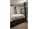 Relaxing main bedroom with four poster bed frame, calm decor, dresser, and soft carpet at 10835 Spirit Dr, Ingalls, IN 46048