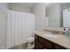 Well-lit bathroom featuring granite counters, a shower with a white curtain, and essential fixtures at 10962 Stoneleigh Dr, Noblesville, IN 46060