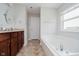Clean bathroom with a soaking tub, granite countertop, and fixtures designed for comfort and functionality at 10962 Stoneleigh Dr, Noblesville, IN 46060