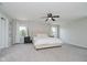 Airy bedroom with a plush bed, soft carpeting, neutral decor, and natural light through two windows at 10962 Stoneleigh Dr, Noblesville, IN 46060