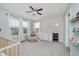 Cozy Bedroom with a ceiling fan, neutral walls, and a comfortable seating area by the windows at 10962 Stoneleigh Dr, Noblesville, IN 46060