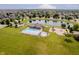 Aerial view of community amenities including pool, playground, and serene pond at 10962 Stoneleigh Dr, Noblesville, IN 46060