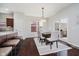 Bright dining area with modern lighting, a dining table, and a sliding glass door at 10962 Stoneleigh Dr, Noblesville, IN 46060
