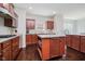 Well-equipped kitchen with wood cabinetry, stone countertops, stainless steel appliances, and a functional center island at 10962 Stoneleigh Dr, Noblesville, IN 46060