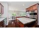 Spacious kitchen featuring stainless steel appliances, a center island, and an adjacent dining area with natural light at 10962 Stoneleigh Dr, Noblesville, IN 46060