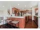 Open kitchen featuring stainless steel appliances, wood cabinets, and a breakfast bar at 10962 Stoneleigh Dr, Noblesville, IN 46060