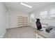 Inviting home office featuring neutral walls, carpeted flooring, and built-in shelving at 10962 Stoneleigh Dr, Noblesville, IN 46060