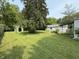 Lush backyard featuring a large shed and mature trees at 11026 N Kitchen Rd, Mooresville, IN 46158