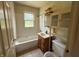 Modest bathroom featuring a tiled tub/shower combo, updated vanity, and ample storage space at 11026 N Kitchen Rd, Mooresville, IN 46158