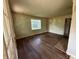 Bright living room with hardwood floors and natural light streaming through the window at 11026 N Kitchen Rd, Mooresville, IN 46158