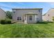 The backyard features a green lawn and views of the back of the house at 11614 Gosling Dr, Indianapolis, IN 46229