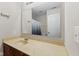 Bathroom with a single sink vanity, large mirror, and a view of the shower at 11614 Gosling Dr, Indianapolis, IN 46229