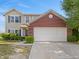Charming two-story home featuring a two-car garage, well-maintained lawn, and inviting curb appeal at 11614 Gosling Dr, Indianapolis, IN 46229