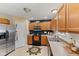 Well-lit kitchen featuring stainless steel appliances, light wood cabinets, and durable countertops at 11614 Gosling Dr, Indianapolis, IN 46229