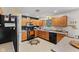 Functional kitchen with black appliances, wooden cabinets, and ample counter space for meal preparation at 11614 Gosling Dr, Indianapolis, IN 46229