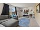 Cozy living room featuring a comfortable gray sectional sofa, large windows, and a modern fireplace at 11614 Gosling Dr, Indianapolis, IN 46229