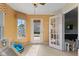 Playroom featuring decorative windows, access to outside deck, and bright natural light throughout at 11614 Gosling Dr, Indianapolis, IN 46229