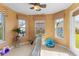 Sunlit playroom featuring bright yellow walls, decorative windows, and fun play equipment for  at 11614 Gosling Dr, Indianapolis, IN 46229
