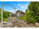 Picturesque backyard shed, framed by greenery and decorative stonework at 1202 Orphant Annie, Greenfield, IN 46140