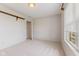 Bedroom features neutral walls and carpet, and a large window at 1202 Orphant Annie, Greenfield, IN 46140