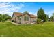 Well-maintained home exterior featuring lush landscaping and a cozy sunroom at 1202 Orphant Annie, Greenfield, IN 46140
