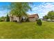 Charming home with lush green grass, mature trees, and well-maintained landscaping at 1202 Orphant Annie, Greenfield, IN 46140