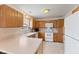 Bright kitchen featuring white appliances and oak cabinets at 1202 Orphant Annie, Greenfield, IN 46140