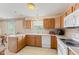 Bright kitchen with white appliances, window, and oak cabinets at 1202 Orphant Annie, Greenfield, IN 46140