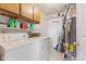 Laundry room with washer and dryer, storage cabinets, and utility sink at 1202 Orphant Annie, Greenfield, IN 46140