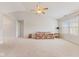 Bright living room with vaulted ceiling, fan, carpet, and large window for natural light at 1202 Orphant Annie, Greenfield, IN 46140