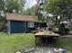 The backyard featuring the home's blue exterior, a wood deck, and a grassy area at 1206 Mcdougal St, Indianapolis, IN 46203