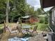 Backyard featuring a wooden deck with chairs and a table, plus a charming red shed at 1206 Mcdougal St, Indianapolis, IN 46203