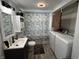 Bathroom with laundry, a gray-veined shower curtain, modern vanity, and updated fixtures at 1206 Mcdougal St, Indianapolis, IN 46203