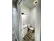 Compact half-bathroom features a white vanity, modern lighting, and a neutral color scheme at 1206 Mcdougal St, Indianapolis, IN 46203