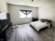 Large bedroom with neutral walls, gray floors and a large window with natural light at 1206 Mcdougal St, Indianapolis, IN 46203