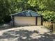 Exterior of the detached garage with a beige door and blue siding at 1206 Mcdougal St, Indianapolis, IN 46203