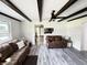 Spacious living room featuring stylish gray flooring, exposed beam ceilings, and abundant natural light at 1206 Mcdougal St, Indianapolis, IN 46203