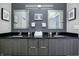 Chic bathroom showcases dual sinks, granite countertops, framed mirrors, and modern light fixture at 1209 Cottage Ave, Indianapolis, IN 46203