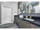 Contemporary bathroom featuring dual sinks, dark granite countertops, and modern vanities at 1209 Cottage Ave, Indianapolis, IN 46203