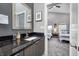Modern bathroom featuring a black granite countertop and a glimpse into an adjacent bedroom at 1209 Cottage Ave, Indianapolis, IN 46203