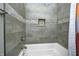 Modern bathroom features a tub with stone tile and built-in niche for bath accessories at 1209 Cottage Ave, Indianapolis, IN 46203