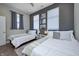 Cozy bedroom with two twin beds, a window with natural light, and neutral décor at 1209 Cottage Ave, Indianapolis, IN 46203