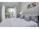 Well-lit bedroom with deck access offering outdoor views through sheer white curtains at 1209 Cottage Ave, Indianapolis, IN 46203