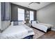 Well-lit bedroom furnished with two twin beds, side table, and art at 1209 Cottage Ave, Indianapolis, IN 46203