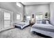Sunny bedroom features two beds, neutral wall color, and modern lighting at 1209 Cottage Ave, Indianapolis, IN 46203