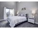 Bright bedroom featuring a king bed with deck access and high ceilings with transom window at 1209 Cottage Ave, Indianapolis, IN 46203